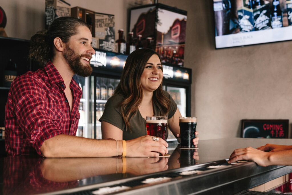 A lively scene of friends laughing and engaging in a casual conversation, illustrating the joy and connection of socializing in a vibrant, welcoming environment